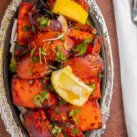 Paneer Tikka · Cubes of cottage cheese, bell pepper, onion, and tomatoes marinated in tandoori masala and g...