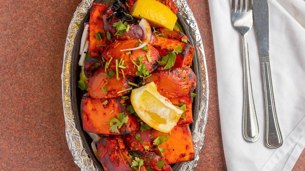 Paneer Tikka · Cubes of cottage cheese, bell pepper, onion, and tomatoes marinated in tandoori masala and grilled in the clay oven.