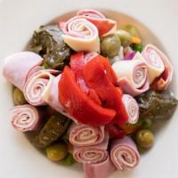 Antipasto · Fresh mix of romaine & iceberg lettuce, tomato, onion, grape leaves, roasted red peppers, gr...