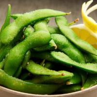 Edamame · Steamed edamame pods, salted and served with a wedge of lemon.