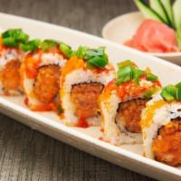 Mexican Roll · Spicy tuna, spicy salmon, crunch, topped with jalapeno, masago & a dollop of hot chili.