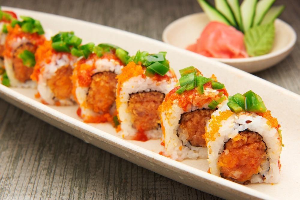 Mexican Roll · Spicy tuna, spicy salmon, crunch, topped with jalapeno, masago & a dollop of hot chili.