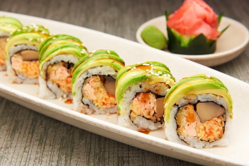 Tiger Roll · Tempura'd salmon, spicy kani, portabella, fried onion, wrapped with avocado, topped with fried onion.