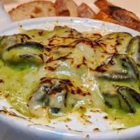 Escargot · Mornay sauce with a touch of herbs and parmesan cheese.