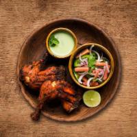 Charred Tandoori Chicken · Chicken marinated overnight in a prepared mix of yogurt, spices, herbs, and cooked in a clay...