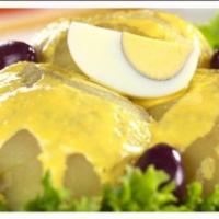 Papa A La Huancaina · Boiled potatoes smothered in a cheese sauce, egg, and Peruvian black olives.