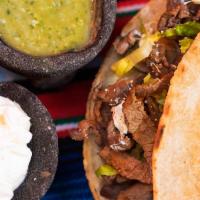 Steak Quesadilla (2 Pcs) · Two warm grilled flour tortillas filled with cheese fresh lettuce, Cotija powder cheese, and...
