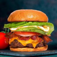 War Of Bacon & Egg Burger · American beef patty cooked medium rare and topped with bacon, fried egg, avocado, melted che...