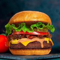 Quirky Classic Burger · American beef patty topped with buttered lettuce, tomato, onion, and pickles. Served on a wa...