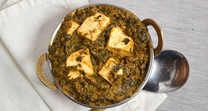 #25. Palak Paneer · Minced spinach with homemade cheese cubes in a light creamy sauce.