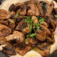 Hummus Masbacha With Sautéed Mushrooms · Our Homemade Hummus topped with sautéed pepper mushrooms, with Harissa on the side