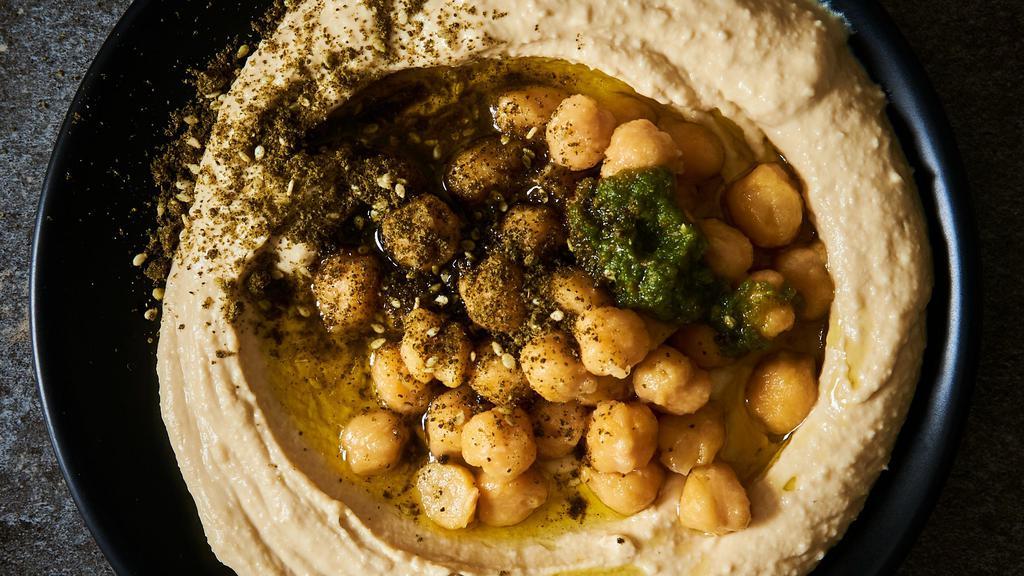 Hummus 'Masbacha' With Evoo & Za'Atar · Served with one pita on the side.