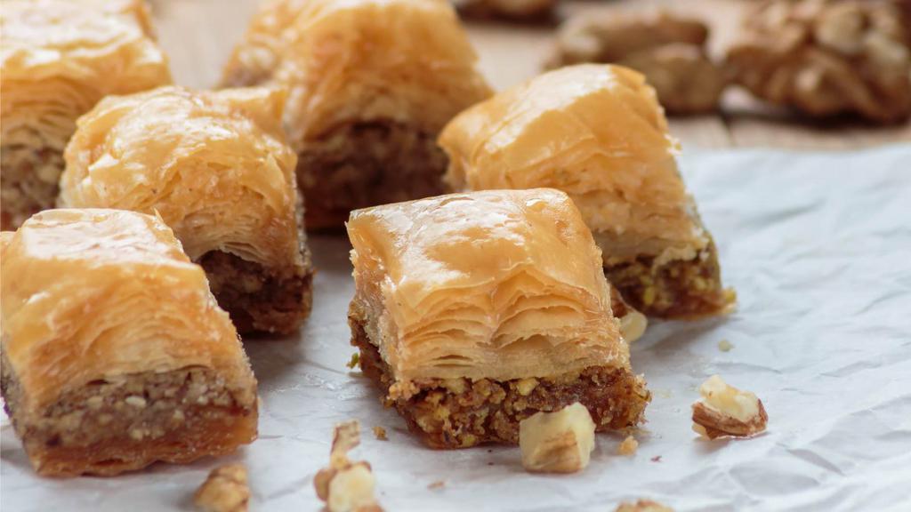 Baklava · Walnut and pistachio in between layers of filo pastry topped with a sugar syrup.