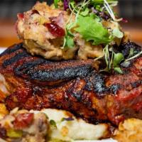 Center Cut Pork Chop · pan seared and smothered in an apple cider glaze and topped with a crumbled sausage stuffing...