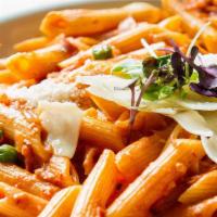 Penne A La Vodka · Penne pasta, house made vodka sauce, rendered prosciutto and peas topped with parmesan.