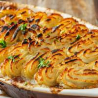 Shepherd'S Pie · Seasoned ground beef, diced carrots, onions and fresh peas topped with a piped layer of mash...