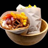 Halal Gyro Wrap With Fries · Homemade pita bread filled with beef gyro. Garnished with lettuce, tomatoes, delicious onion...