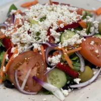 Greek Salad · Tomatoes cucumber onion and olives.