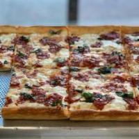 Grandma Slice · With fresh mozzarella, tomato sauce, basil and olive oil.