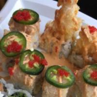 Yellow Taxi Roll · Shrimp tempura, mango topped with spicy yellowtail, tobiko, and jalapeños, drizzled with spi...