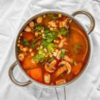 Tom Yum Goong Soup · Spicy shrimp soup. Thai spicy & sour soup with shrimp, lemon grass, mushroom, pepper & lime ...