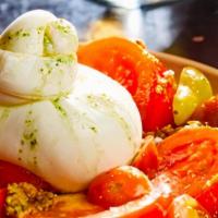 Burrata · Almond tomato herb pesto, organic beefsteak tomatoes, heirloom grape tomatoes,  basil oil