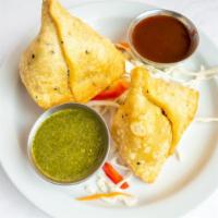 Vegetable Samosa · (Vegan). Mashed potatoes, green peas with spices wrapped in wheat dough and fried.