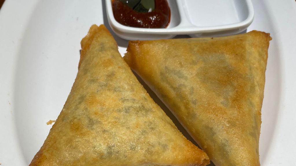 Sambusa · 2 pieces. Pastry dough filled with lentil or spicy beef