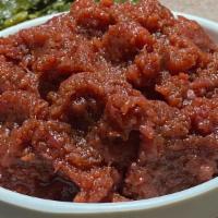 Kitfo · Prime beef tartar seasoned in kibbeh and mitmita with two vegetarian sides except for Enguda...