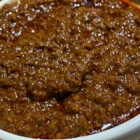 Minchet Abish Spicy · Finely chopped prime beef simmered in a spicy berbere stew. (served with two choices of vege...