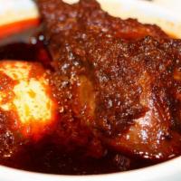 Doro Wot · Chicken legs, slow cooked with onions, berbere sauce served with a hard boiled egg (served w...