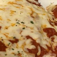 Eggplant Parmigiana  · Breaded eggplant topped with pomodoro sauce and melted mozzarella cheese. served with spaghe...