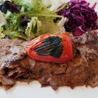 Lamb Gyro · Homemade gyro cooked on rotation spit served with rice and salad.