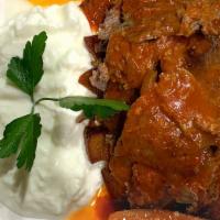 Iskender · Gyro served over bread with yogurt and fresh tomato.