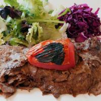 Lamb Doner · Cooked on rotation spit served with rice and salad.