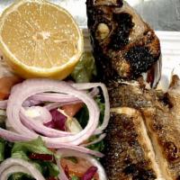 Mediterranean Whole Sea Bass · Char-grilled Served with crispy greens.