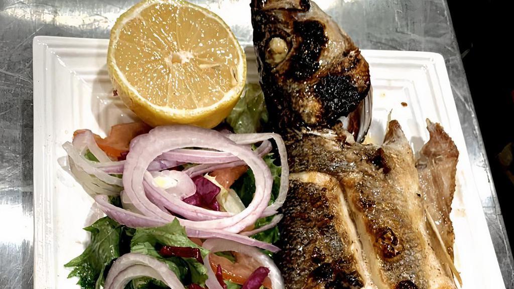Mediterranean Whole Sea Bass · Char-grilled Served with crispy greens.
