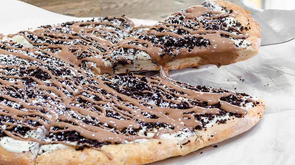 Cookies & Cream Pie · Sweet dough baked with our secret sauce, topped with cookie crumbs and a drizzle of swiss milk chocolate.