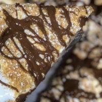 Smores Pie · Sweet dough baked with marshmallow fluff, topped with graham cracker crumbs and a drizzle of...