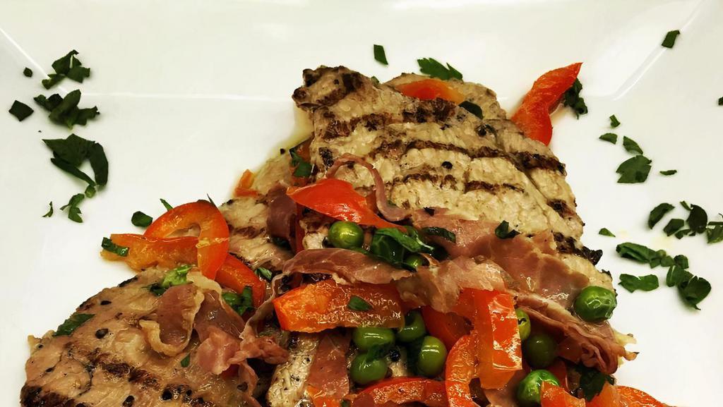 Veal Alla Giuliano · Tender veal with prosciutto, peas, white wine reduction and peppers.