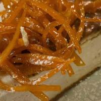 Mama G'S Ricotta Cheesecake · Homemade Ricotta Cheesecake Topped with Candied Orange Peels & Powered Sugar