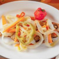Escovitch Fish (Red Snapper) · served with our specially made sauté onions carrots and peppers.