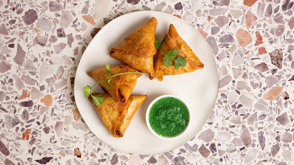 Vegetable Samosa · Golden fried pastry filled with potatoes and green peas.