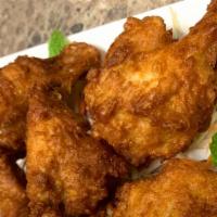 Crispy Wings · Crispy fried chicken wings with sriracha dip.