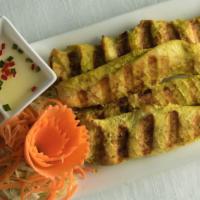 Chicken Satay · Grilled marinated chicken served with peanut and cucumber sauce.