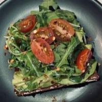 Avocado Toast · Avocado, arugula, cherry tomatoes, crushed peppers, Greek olive oil, and lime on a multigrai...