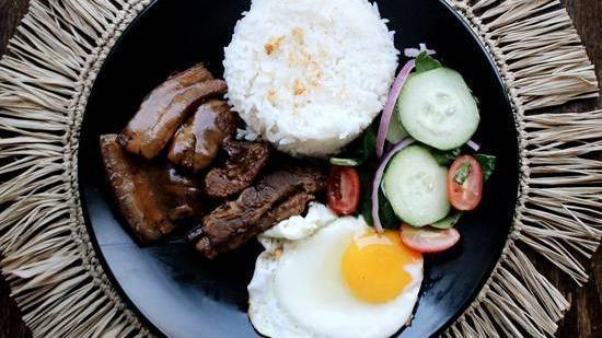 Pork Adobo Plate · Filipino style pool braised in soy sauce, vinegar, bay leaves with fried egg, toasted garlic, white rice, and side salad