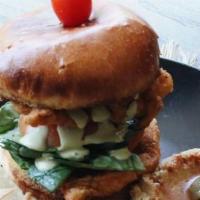 Chicken Sandwich · Breaded chicken, tomato, spinach, onion, pickles, and green sauce on a brioche bun with side...