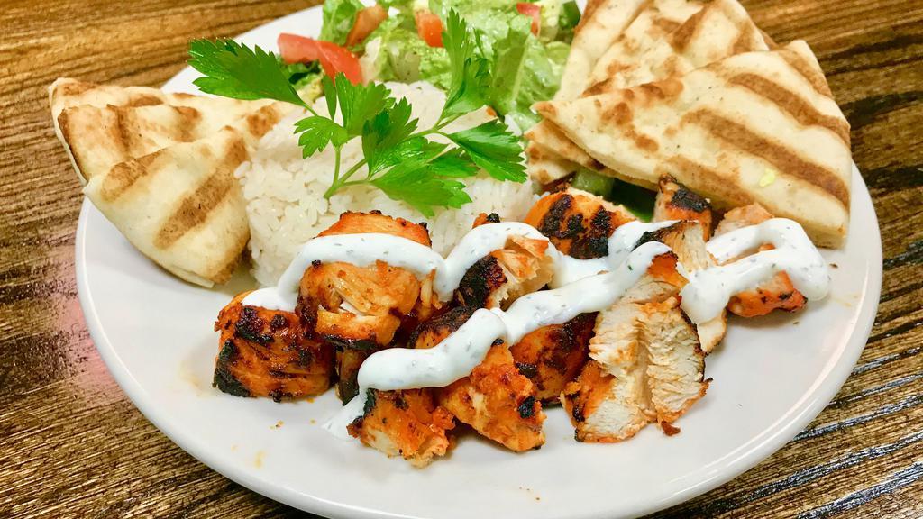 Chicken Kebab Platter · Marinated Chicken Kebab served on a platter with choice of white rice or rice & beans, salad or steamed vegetables with toasted pita bread.
