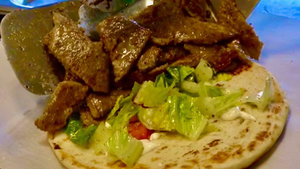 Gyro Pita Sandwich · Gyro is a combination of beef & lamb ground together to produce this delicious meat. Served on pita with lettuce,  tomato, cucumber and tzatziki sauce.